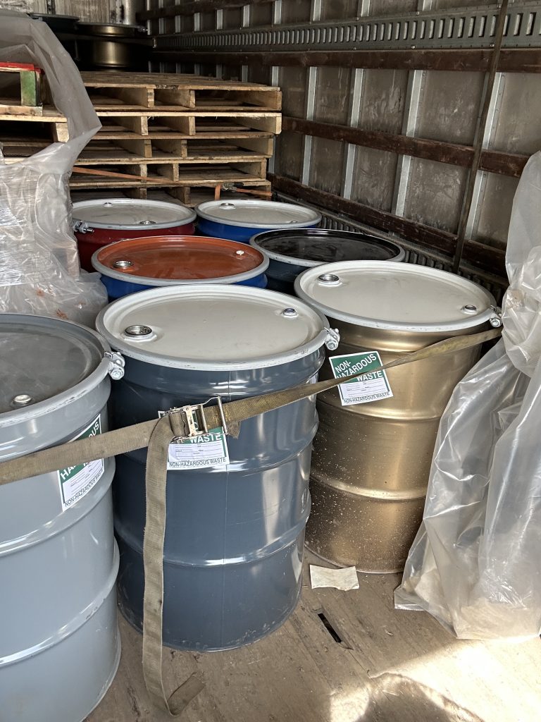 drums of non-hazardous waste for removal after loading dock spill cleanup