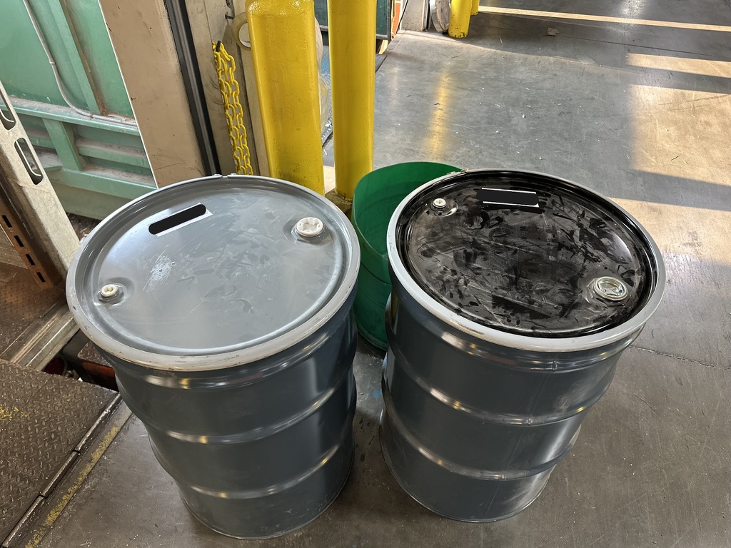 drums of hazardous waste after remediation of flammable paint incident